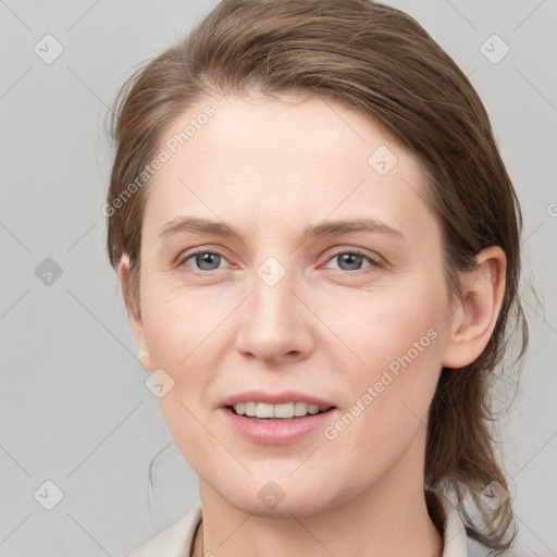 Joyful white young-adult female with medium  brown hair and grey eyes