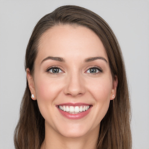 Joyful white young-adult female with long  brown hair and grey eyes