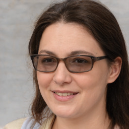 Joyful white adult female with medium  brown hair and brown eyes