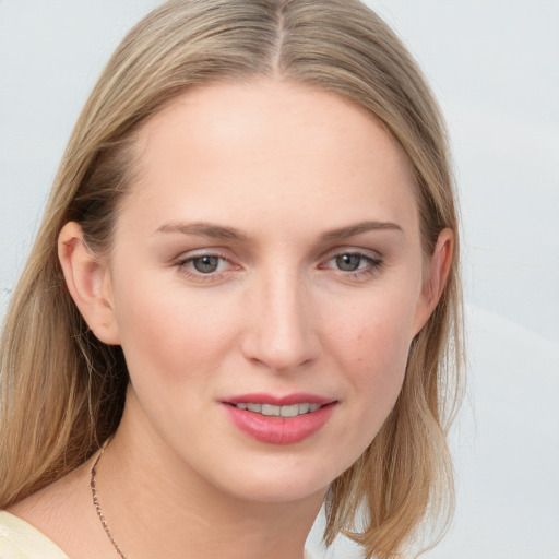 Joyful white young-adult female with medium  brown hair and blue eyes