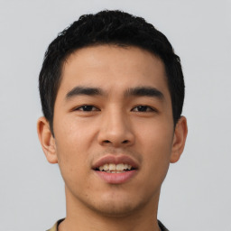 Joyful asian young-adult male with short  black hair and brown eyes