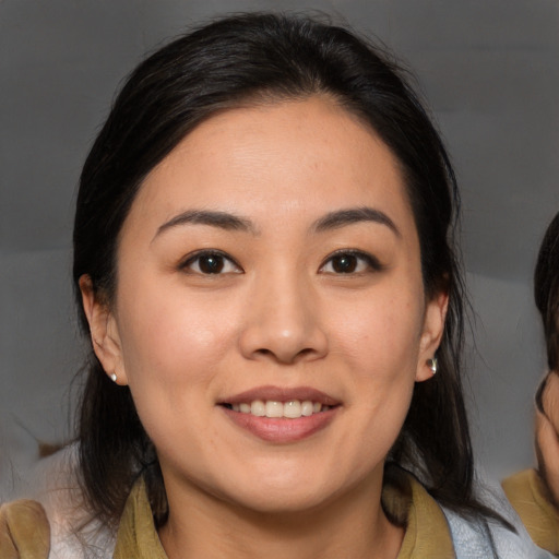 Joyful asian young-adult female with medium  brown hair and brown eyes