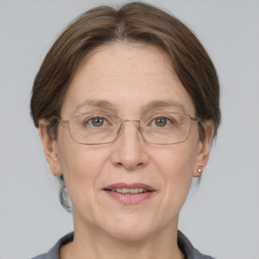 Joyful white middle-aged female with medium  brown hair and grey eyes