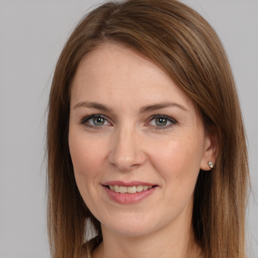 Joyful white young-adult female with long  brown hair and grey eyes