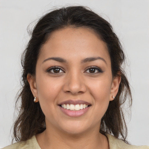 Joyful latino young-adult female with medium  brown hair and brown eyes