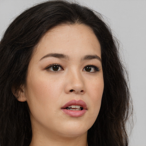 Joyful asian young-adult female with long  brown hair and brown eyes