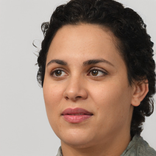 Joyful latino young-adult female with short  brown hair and brown eyes