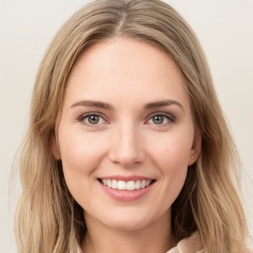 Joyful white young-adult female with long  brown hair and green eyes