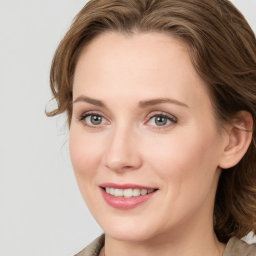 Joyful white young-adult female with medium  brown hair and blue eyes