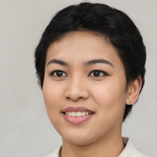 Joyful asian young-adult female with short  black hair and brown eyes