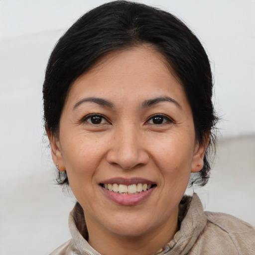 Joyful white adult female with medium  brown hair and brown eyes
