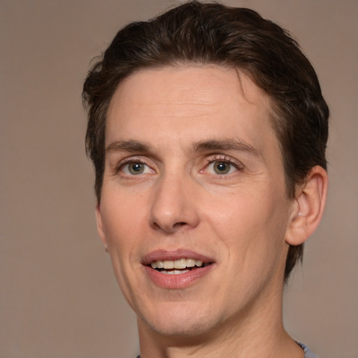 Joyful white adult male with medium  brown hair and brown eyes