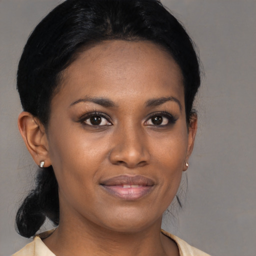 Joyful black young-adult female with medium  black hair and brown eyes