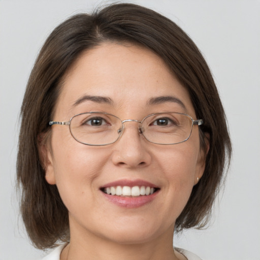 Joyful white adult female with medium  brown hair and brown eyes