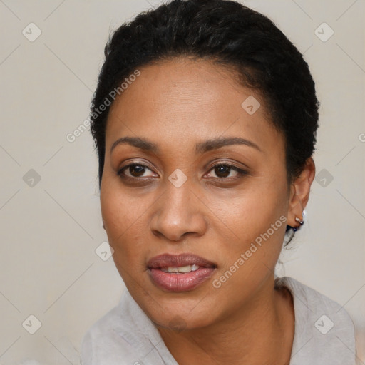 Joyful black young-adult female with short  black hair and brown eyes