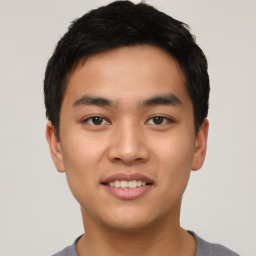 Joyful asian young-adult male with short  black hair and brown eyes