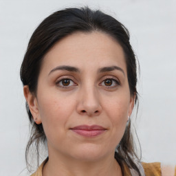 Joyful white adult female with medium  brown hair and brown eyes