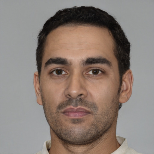 Neutral latino young-adult male with short  black hair and brown eyes