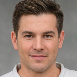 Joyful white adult male with short  brown hair and brown eyes