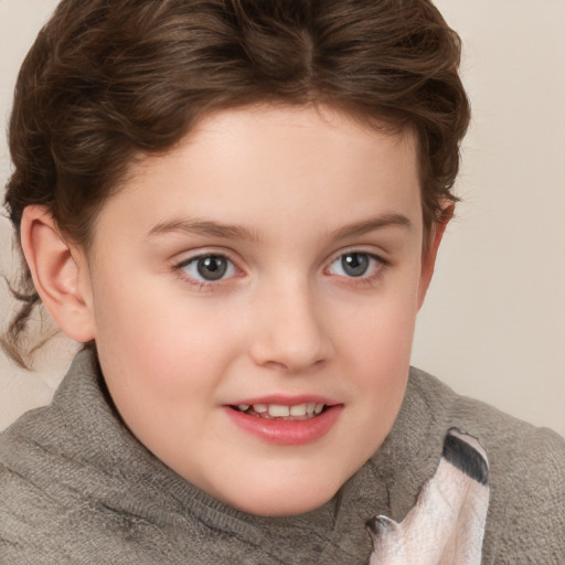 Joyful white child female with short  brown hair and blue eyes