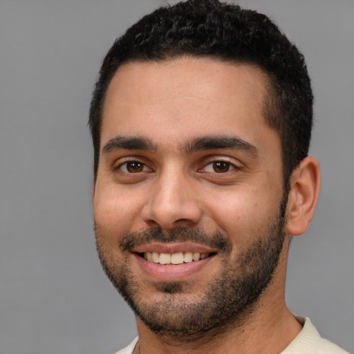 Joyful white young-adult male with short  black hair and brown eyes