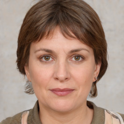 Joyful white adult female with medium  brown hair and grey eyes