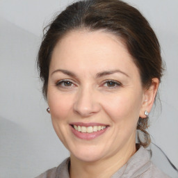 Joyful white adult female with medium  brown hair and brown eyes