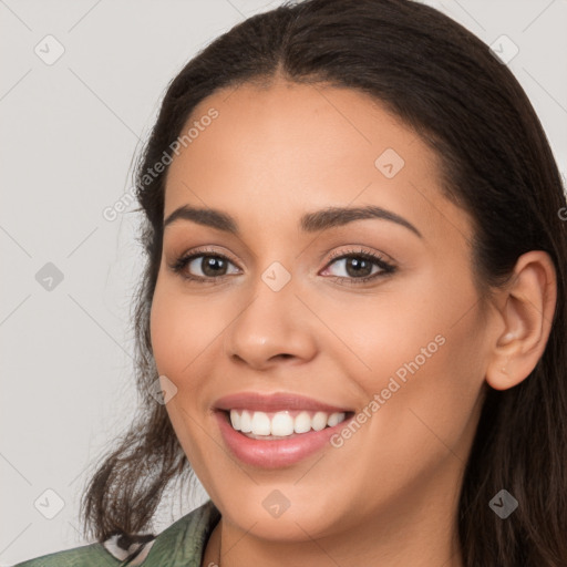 Joyful white young-adult female with long  brown hair and brown eyes