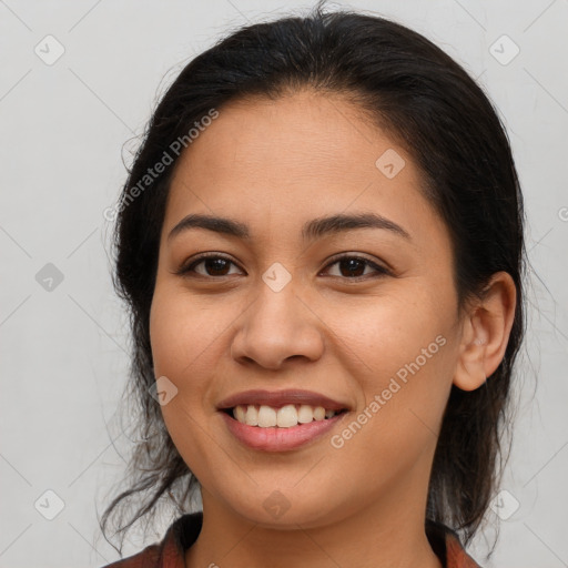 Joyful latino young-adult female with long  brown hair and brown eyes