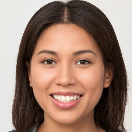 Joyful white young-adult female with long  brown hair and brown eyes