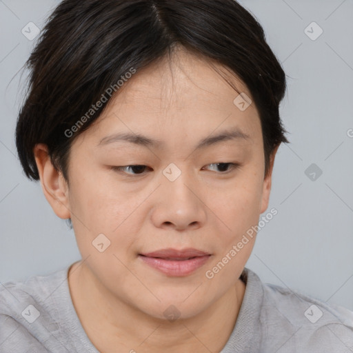 Joyful asian young-adult female with short  brown hair and brown eyes