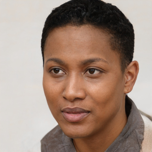Joyful black young-adult female with short  black hair and brown eyes