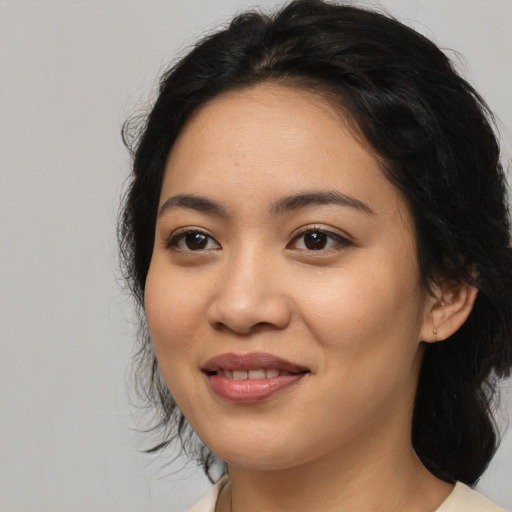 Joyful white young-adult female with medium  black hair and brown eyes