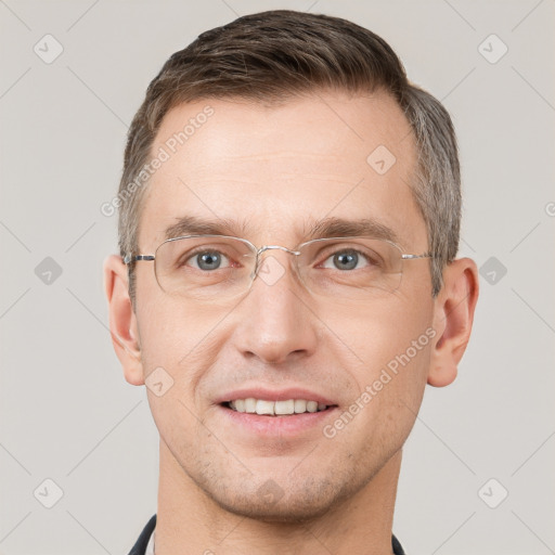 Joyful white adult male with short  brown hair and grey eyes