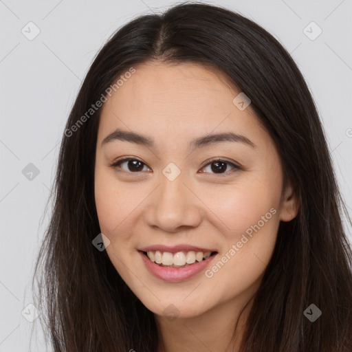 Joyful asian young-adult female with long  brown hair and brown eyes