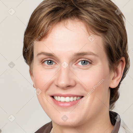 Joyful white young-adult female with medium  brown hair and blue eyes