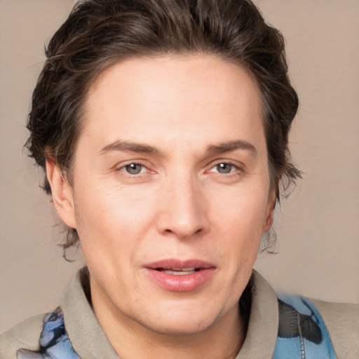 Joyful white adult male with medium  brown hair and brown eyes