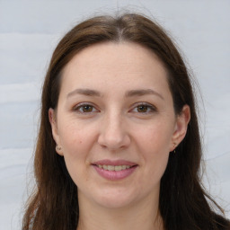 Joyful white young-adult female with long  brown hair and grey eyes