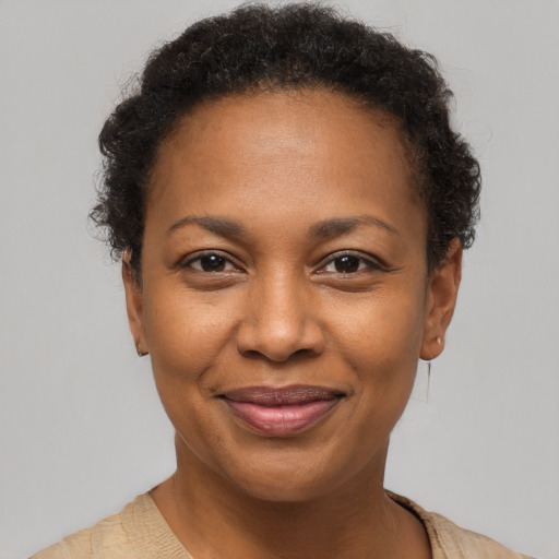 Joyful black adult female with short  brown hair and brown eyes
