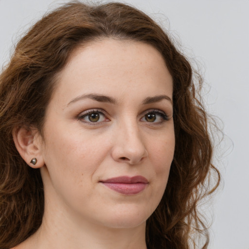 Joyful white young-adult female with long  brown hair and green eyes