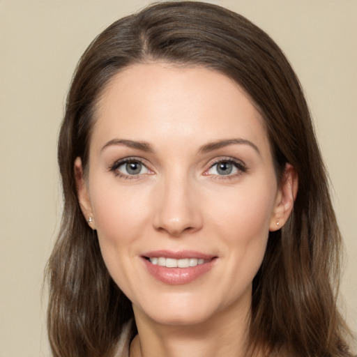 Joyful white young-adult female with long  brown hair and brown eyes