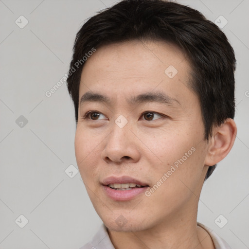 Joyful white young-adult male with short  black hair and brown eyes