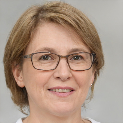 Joyful white middle-aged female with medium  brown hair and blue eyes