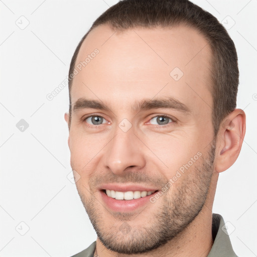 Joyful white young-adult male with short  brown hair and brown eyes