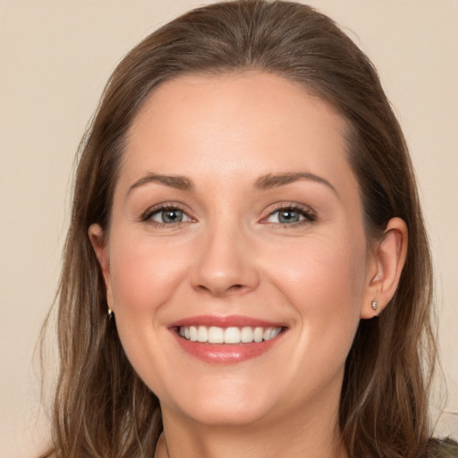 Joyful white young-adult female with long  brown hair and grey eyes