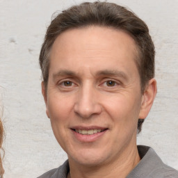 Joyful white adult male with short  brown hair and grey eyes