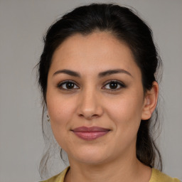 Joyful latino young-adult female with medium  brown hair and brown eyes