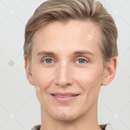 Joyful white young-adult male with short  brown hair and grey eyes