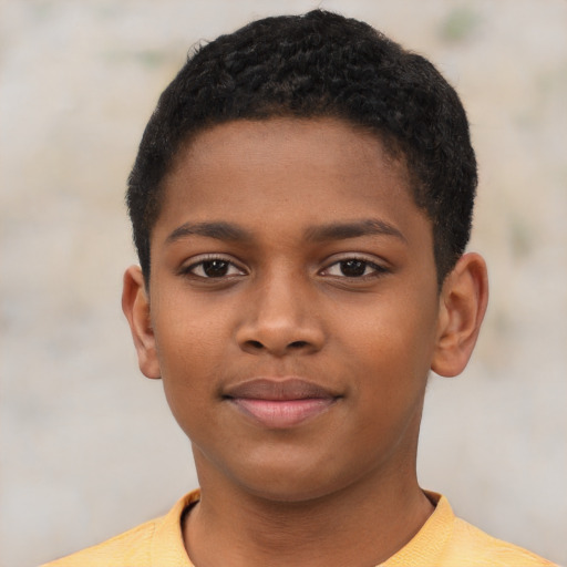 Joyful black child male with short  black hair and brown eyes