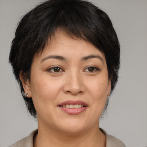 Joyful asian adult female with medium  brown hair and brown eyes
